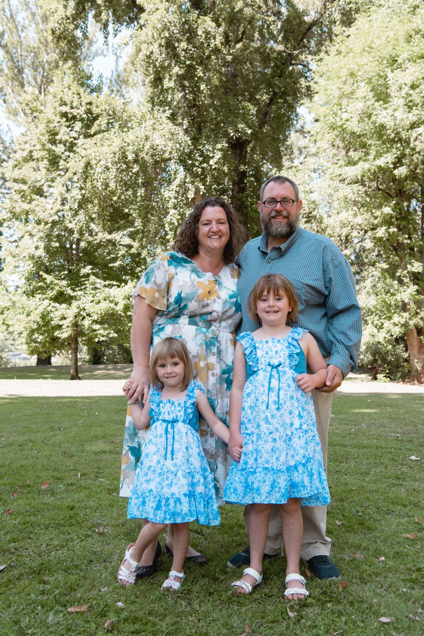 Jonathan and Andrea Dowell with Madison and Sophia, standing together outdoors